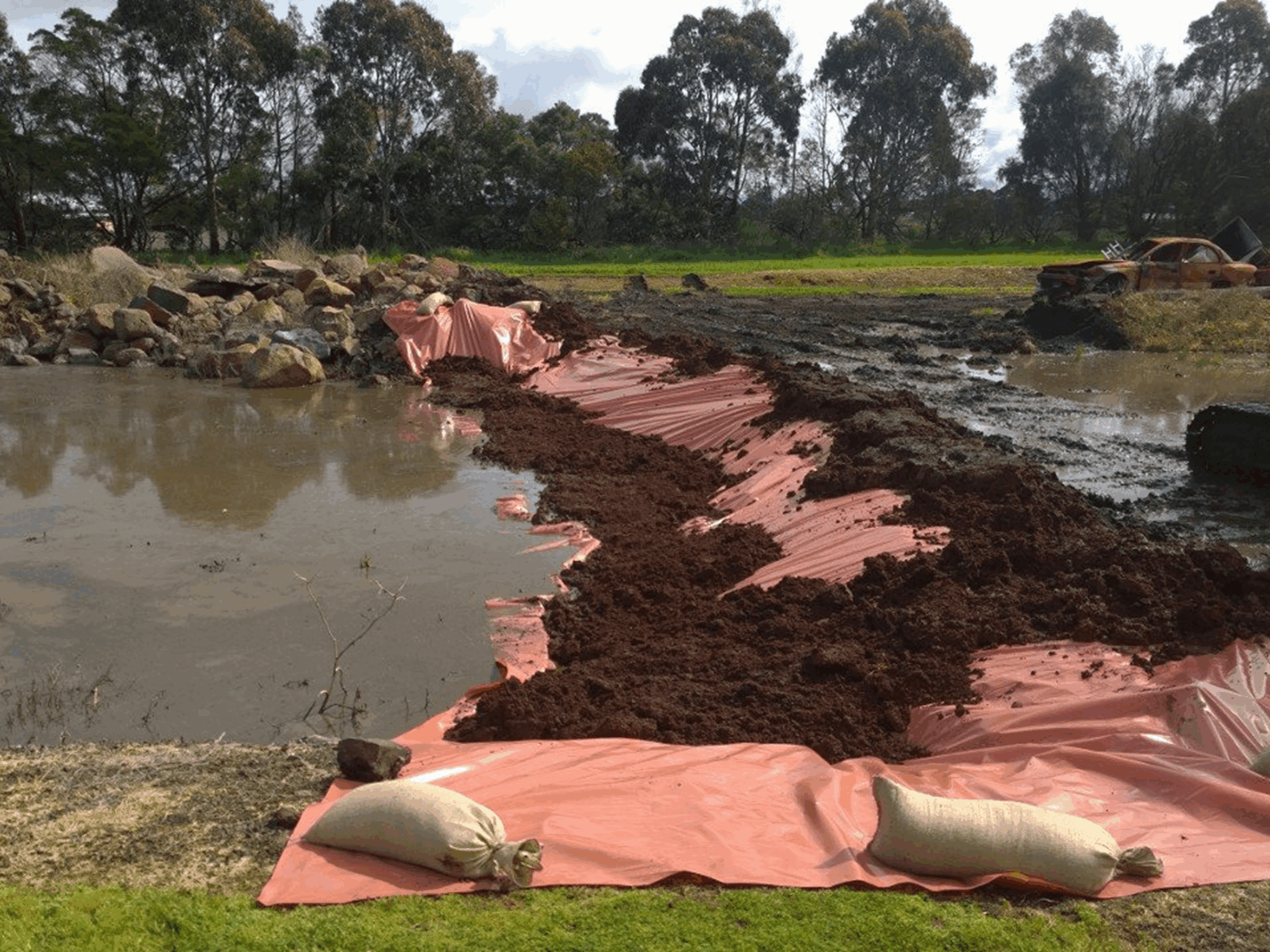 Construction site with mud and water barriers.